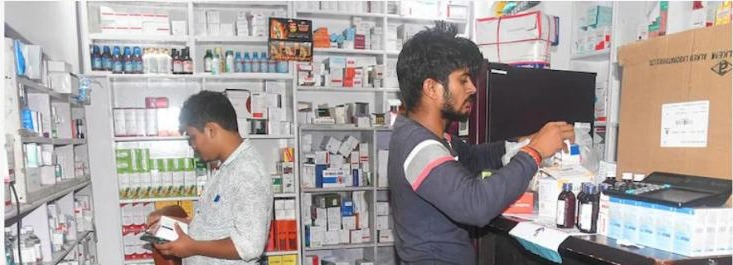 Locals wading through a flooded medicine store in Patna
